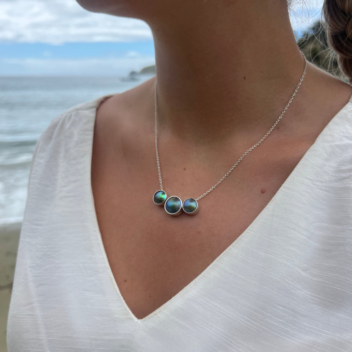 June birthpearl necklace featuring natural New Zealand paua pearl thread through setting
