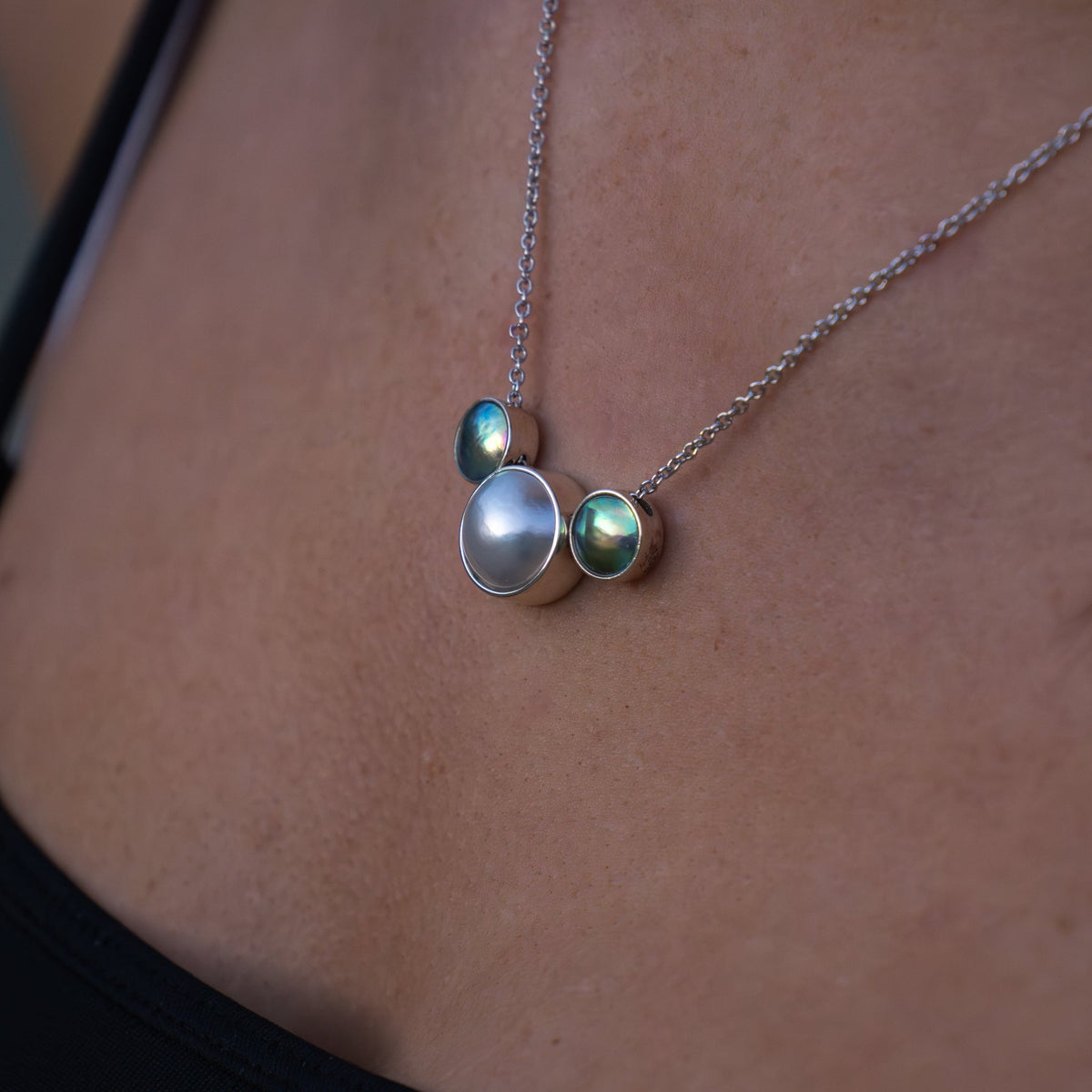 White gold pearl necklace NZ featuring a pāua and Australian white pearl duo pendant