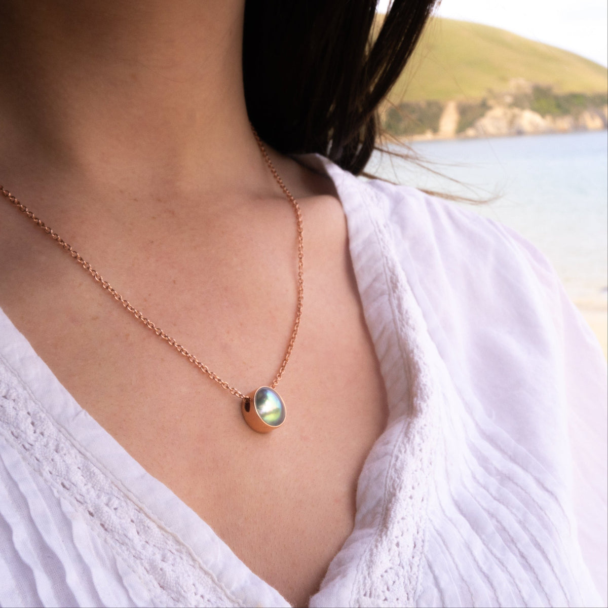 Close-up of a pearl necklace NZ with 12.5mm paua pearl and polished rose gold mount