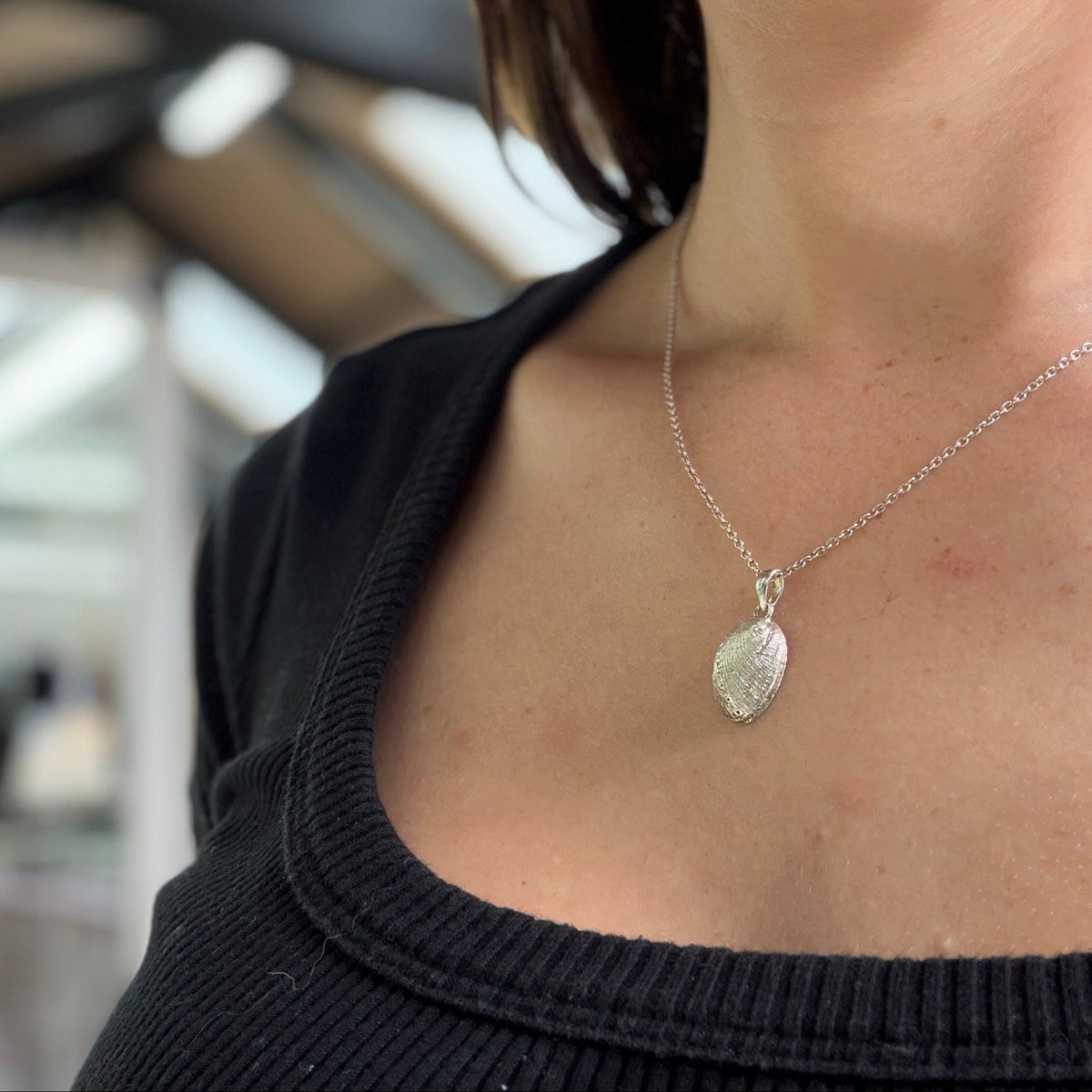 Close-up of a natural New Zealand paua shell set in sterling silver
